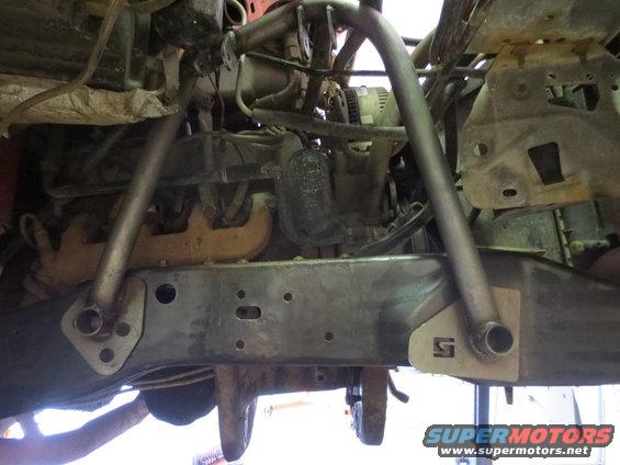 Engine and chassis components with a visible 'S' logo on a bracket