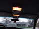 1999 Mercury Grand Marquis - Interior view of a car's overhead console with lights illuminated, showing sun visors and a house outside.