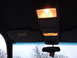 1999 Mercury Grand Marquis - Interior view of a vehicle's overhead console and sun visor, with illuminated lights.