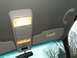 1999 Mercury Grand Marquis - Interior view of a car's overhead console, sun visor, and rearview mirror, with trees visible through the windshield.