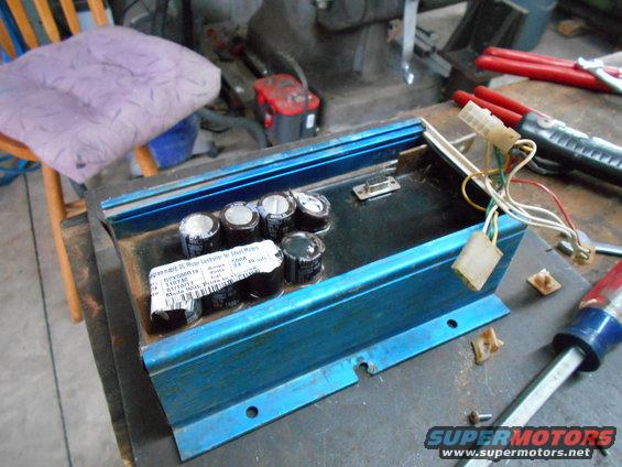 Blue electronic motor controller with capacitors and wiring harness. Label reads 'Programmable DC Motor Controller for Mini Motors'