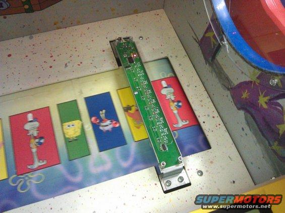 Arcade game interior with Spongebob characters and a circuit board