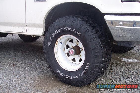 close-up of a white pickup truck's front wheel with a Goodyear Wrangler tire