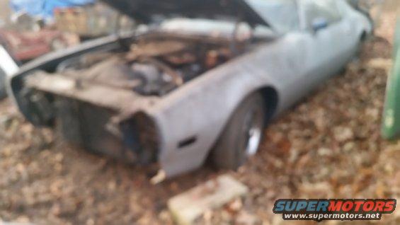 1970 Pontiac Firebird with hood open, missing front bumper and grille, parked outdoors