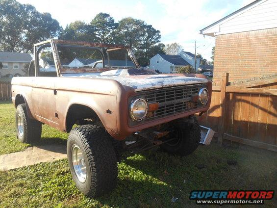Rusty 1972 Ford Bronco with no top, sitting in a yard
