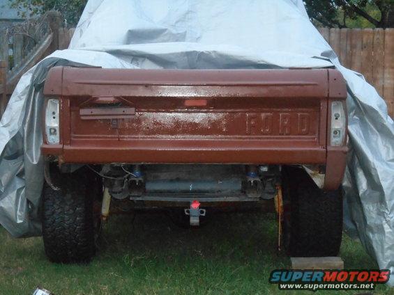 1972 Ford Bronco rear view, tailgate painted brown, partially covered