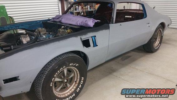Gray primer 1970 Pontiac Trans Am with hood open, undergoing restoration