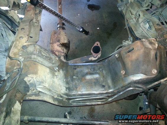 Vehicle frame with exhaust pipe and catalytic converter visible