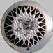 1999 Mercury Grand Marquis - Close-up of a Mercury wheel, a detailed spoke pattern and the brand's emblem in the center.