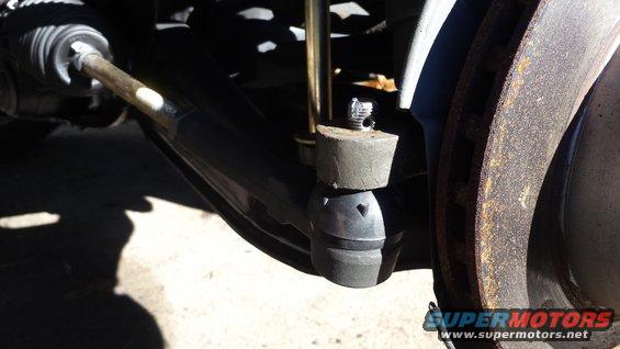 Close-up of a car's tie rod end and brake rotor