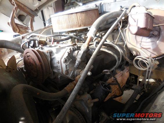 Engine bay with V8 engine, air cleaner, and AC compressor visible