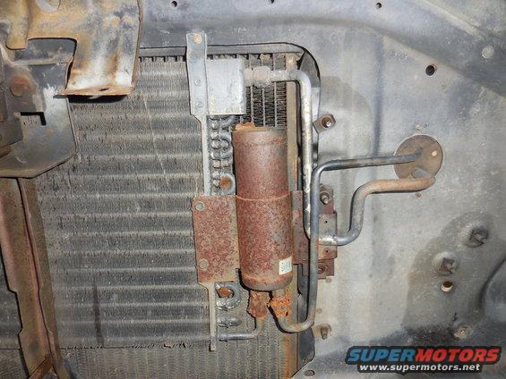 Radiator and AC condenser assembly with rusty lines and canister