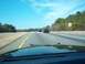 2001 Ford Crown Victoria - A view from inside a car driving on a highway on a clear day, with other vehicles ahead.
