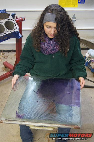 All the door windows had purple tint on them that Nicole said had to go. She and her friend Baites scraped for a couple hours but the glass underneath looked great. By looking at Nicole you would think we have no heat in the shop.