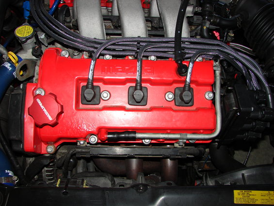 Red ignition coil pack in engine bay