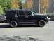 2003 Lincoln Aviator - Side view of a black 2003 Lincoln Aviator SUV with aftermarket black wheels.
