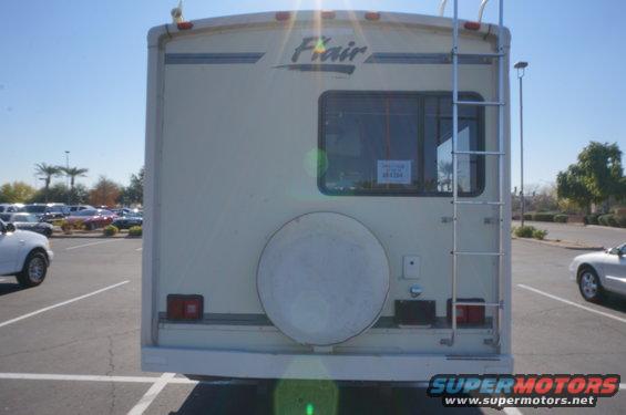 RV rear with ladder, spare tire, and 'Flair' badging