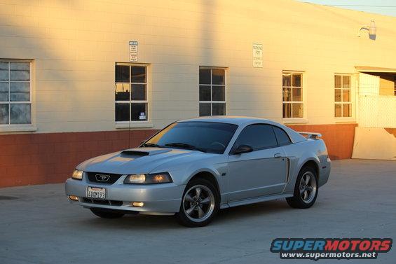Silver 2002 Ford Mustang coupe parked outside a building