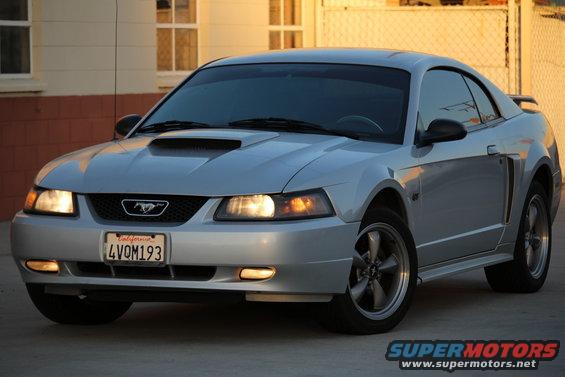 Silver 2002 Ford Mustang coupe with a hood scoop and a California license plate