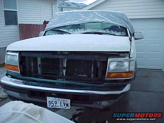 Front view of a 1996 Ford Bronco covered in snow