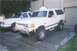 1988 Ford Bronco - A white Ford Bronco is parked in a driveway next to another vehicle.