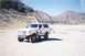 1988 Ford Bronco - 1988 Ford Bronco parked in a dry, mountainous area with a person standing next to it.