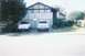 1988 Ford Bronco - Two SUVs are parked in a driveway in front of a house with a basketball hoop.