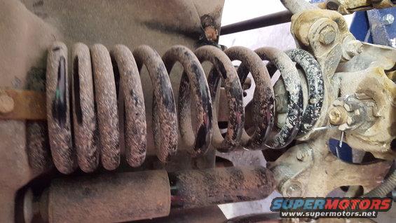Suspension coil spring and shock absorber with SuperMotors.net watermark