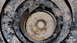 1995 Ford Bronco - This image shows a close-up view of a rusty bolt and nut securing a suspension component on a vehicle.