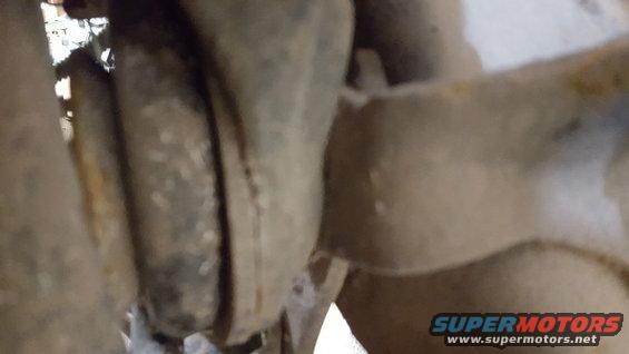 Close-up of heavily rusted metal components, possibly from a vehicle's undercarriage