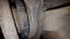 1995 Ford Bronco - This image shows a close-up view of a heavily soiled vehicle suspension component, with no clear identifying features.