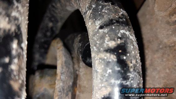 Close-up of dirty transfer case parts with white residue
