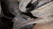 1995 Ford Bronco - Underside view of vehicle suspension components, showing rust and wear on metal parts.