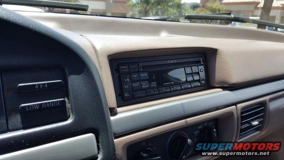 Dashboard interior of a 1995 Ford Bronco showing the radio, 4x4 and low range buttons