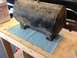1979 Ford Bronco - A dirty black air tank rests on a workbench, ready for installation or repair.