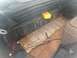1979 Ford Bronco - The interior of an older vehicle shows a socket wrench and a yellow storage box on the floor.