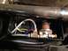 1979 Ford Bronco - Close-up of an air suspension valve and associated tubing, mounted within a black housing.