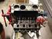1979 Ford Bronco - Engine block on a stand, showing pistons and valve train components during a rebuild.