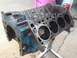 1979 Ford Bronco - Engine block on a stand, showing cylinder bores and some blue paint with rust.