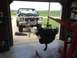 1979 Ford Bronco - An engine is being removed from a Ford truck in a garage, with a field visible in the background.
