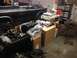 1979 Ford Bronco - A black 1979 Ford Bronco is parked in a garage with various engine components and tools scattered around, suggesting an ongoing rebuild.