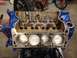 1979 Ford Bronco - A V8 engine block is shown with pistons installed in the cylinders, resting on an engine stand.