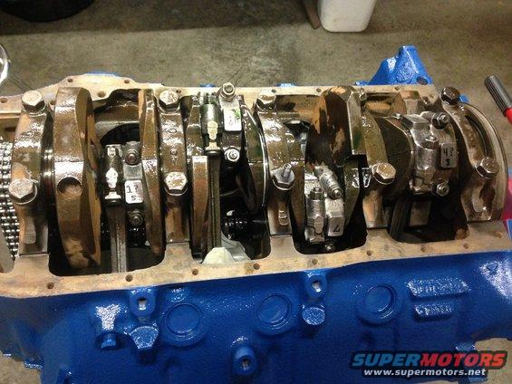 Engine block with crankshaft and connecting rods visible. Some parts have numerical markings