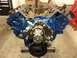 1979 Ford Bronco - A blue V8 engine, likely undergoing a rebuild, is displayed on a stand in a workshop setting.