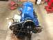 1979 Ford Bronco - A freshly painted engine assembly sits on a stand in a workshop, ready for installation.