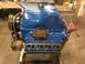 1979 Ford Bronco - A blue engine sits on a stand, ready for installation.
