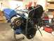 1979 Ford Bronco - Engine assembly on a stand, blue valve covers and black serpentine belt system.