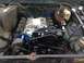 1979 Ford Bronco - Engine bay view shows a V8 engine with blue painted block and black accessories.