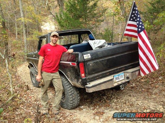 Black 1979 Ford F-150 pickup truck with American flag on rear