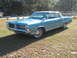 1972 Ford Ranchero - A light blue 1963 Pontiac Bonneville two-door hardtop sits on a grassy lawn under a bright sky.
